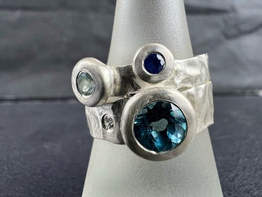 Kelly-Hopkins, Deborah – Silver ring with blue topaz, aquamarine, sapphire and diamond.