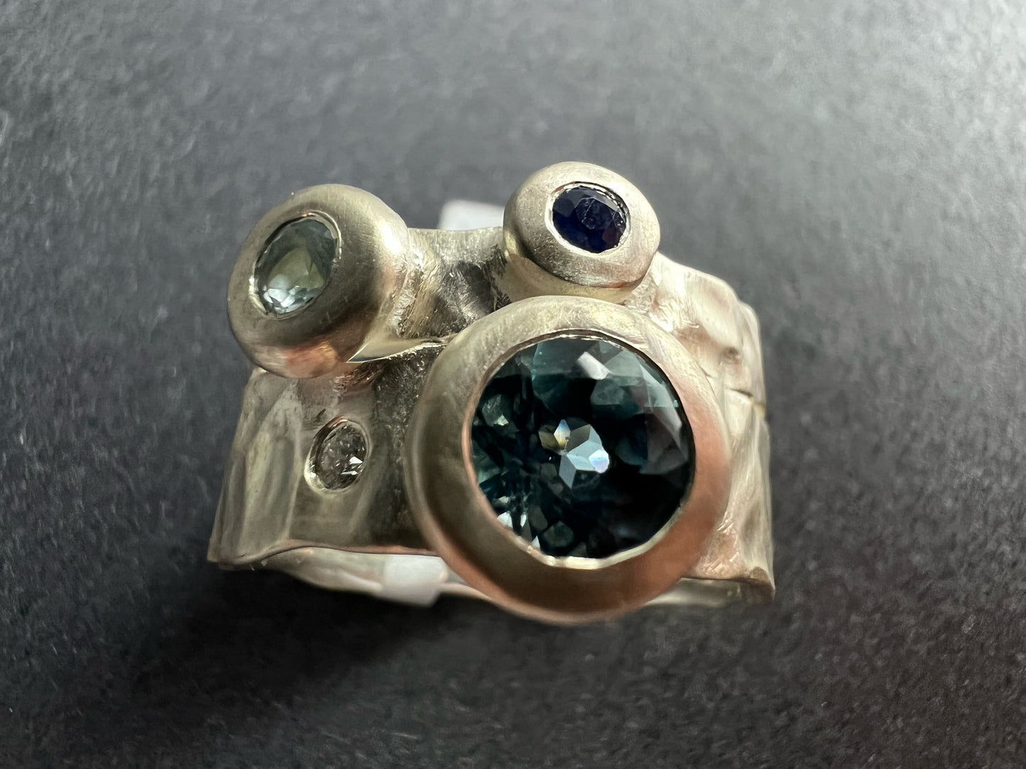 Kelly-Hopkins, Deborah – Silver ring with blue topaz, aquamarine, sapphire and diamond.