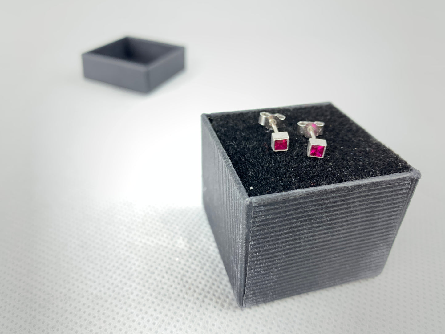 Betts, Malcolm - Platinum stud earrings with square cut pink sapphire